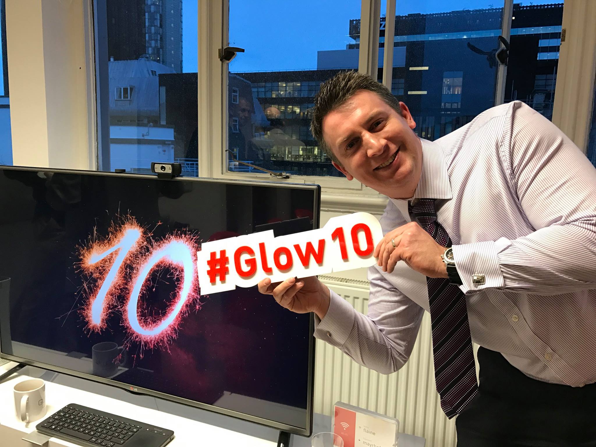 Posing with a glow10 sign